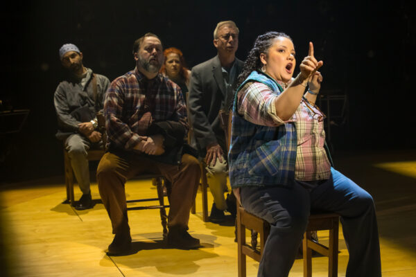 Passengers of the plane encounter a moose in the middle of the road as they're transported to temporary lodgings in the IRT's production of "Come From Away." (Photo/Zach Rosing)