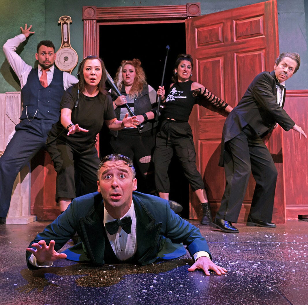 Max (Joey Boos), front, falls to the stage floor after breaking through a stuck set door in Beef & Boards Dinner Theatre’s production of “The Play That Goes Wrong.” (Photo/Indy Ghost Light)