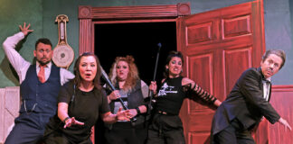 Max (Joey Boos), front, falls to the stage floor after breaking through a stuck set door in Beef & Boards Dinner Theatre’s production of “The Play That Goes Wrong.” (Photo/Indy Ghost Light)
