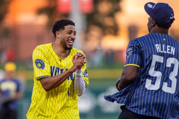 Indiana Pacers guard Tyrese Haliburton shares a laugh with a fellow participant on the field during the charity softball game. (Photo/Josh Herd)