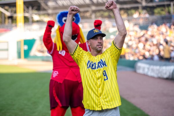 Indiana Pacers guard T.J. McConnell raises his fists in excitement while Freddy Fever cheers in the background. (Photo/Josh Herd)