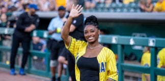 Olympic gold medalist Simone Biles Owens smiles and waves to the fans from the sidelines at Victory Field. (Photo/Josh Herd)