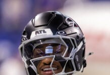 An Atlanta Falcons player smiles and flashes a diamond grill on the sidelines during the decisive 34-6 preseason victory over the Colts. (Photo/Walt Thomas)