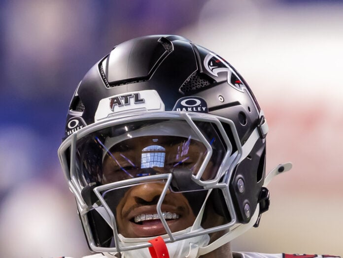An Atlanta Falcons player smiles and flashes a diamond grill on the sidelines during the decisive 34-6 preseason victory over the Colts. (Photo/Walt Thomas)