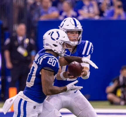 Indianapolis Colts quarterback Riley Leonard (#15) hands the ball off to running back Seth McGowan (#20) in the backfield. (Photo/Walt Thomas)
