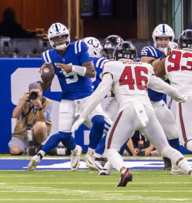 Indianapolis Colts quarterback Anthony Richardson Sr. (#5) looks downfield to pass while under heavy pressure from Atlanta Falcons linebacker Josh Woods (#46) and defensive lineman Chris Williams (#93) on Aug. 22 at Lucas Oil Stadium. (Photo/Walt Thomas)