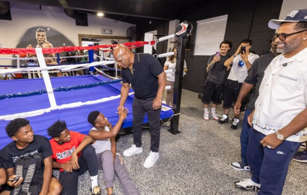 Mike Tyson greets aspiring boxers ringside as comedian and gym owner Mike Epps (right) looks on during the youth workshop on Aug. 28, 2026, at The Right Jab boxing gym, located at 3737 Sutherland Ave, in Indianapolis. (Photo/Walt Thomas)