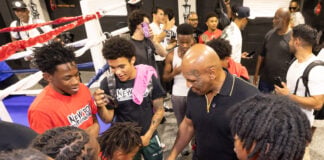 Photo 6: Mike Tyson gathers with a group of young fighters and community members inside the gym to offer encouragement and ring advice on Aug. 28, 2026, at The Right Jab boxing gym, located at 3737 Sutherland Ave, in Indianapolis. (Photo/Walt Thomas)