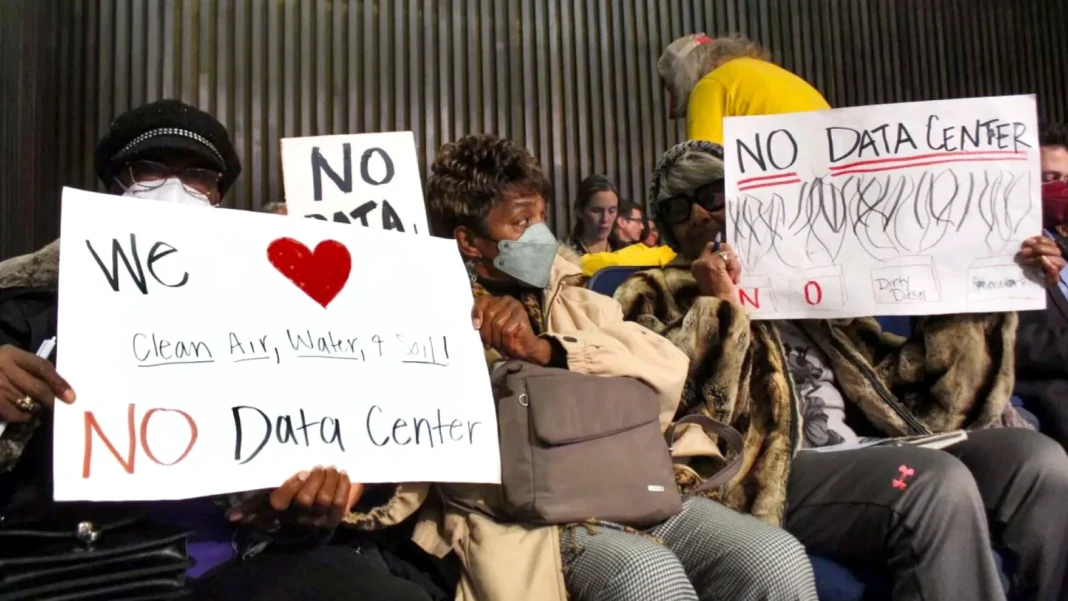 Residents hold signs in opposition to the proposed data center in the Martindale-Brightwood neighborhood on Thursday, Jan. 15, 2026 during the Metropolitan Development Commission meeting. The development was later approved to open.
