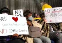 Indy council advances pause on data centers, sends to commission for final approval Residents hold signs in opposition to the proposed data center in the Martindale-Brightwood neighborhood on Thursday, Jan. 15, 2026 during the Metropolitan Development Commission meeting. The development was later approved to open.