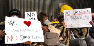 Residents hold signs in opposition to the proposed data center in the Martindale-Brightwood neighborhood on Thursday, Jan. 15, 2026 during the Metropolitan Development Commission meeting. The development was later approved to open.