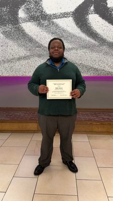 Staff Writer Malik Simon holds up the HSPA Award presented to the Indianapolis Recorder for best business/economic news coverage (Photo/Recorder File Photo)