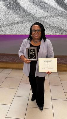 Editor-in-chief Camike Jones holds up the HSPA Award presented to the Indianapolis Recorder for best editorial writer.