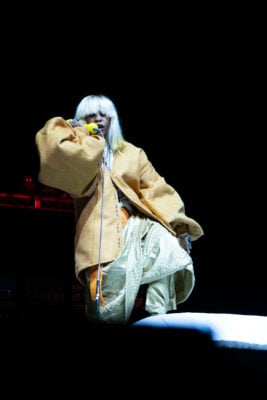 Erykah Badu crouches on stage while performing with a vintage telephone prop on Sept. 22, 2026, at the Everwise Amphitheater at White River State Park, in Indianapolis, Indiana. (Photo/Mia Moore)