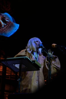 Erykah Badu performs behind a keyboard stand with her hands raised to the audience on Sept. 22, 2026, at the Everwise Amphitheater at White River State Park, in Indianapolis, Indiana. (Photo/Mia Moore)