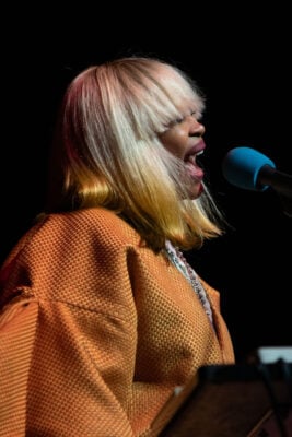Erykah Badu sings passionately into the microphone during her live performance on Sept. 22, 2026, at the Everwise Amphitheater at White River State Park, in Indianapolis, Indiana. (Photo/Mia Moore)