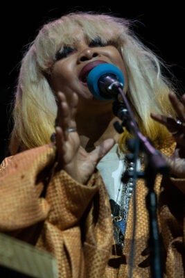 Erykah Badu sings passionately into the microphone with her hands raised during her performance on Sept. 22, 2026, at the Everwise Amphitheater at White River State Park, in Indianapolis, Ind. (Photo/Mia Moore)