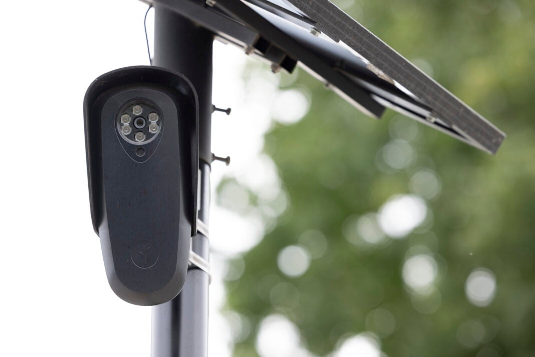 Fullerton, California, USA - August 14, 2026: An AI Flock camera surveils a city street for car license plates.