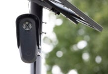 Fullerton, California, USA - August 14, 2026: An AI Flock camera surveils a city street for car license plates.