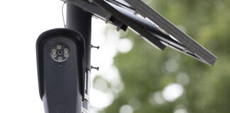 Fullerton, California, USA - August 14, 2026: An AI Flock camera surveils a city street for car license plates.