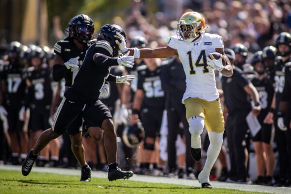 Notre Dame wide receiver Micah Gilbert (#14) stiff-arms a Purdue Boilermakers defender while running with the football on Sept. 26, 2026, at Ross-Ade Stadium, in West Lafayette, Ind. (Photo/Josh Herd)