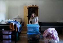Valerie Lakes packs up her belongings to move to another room on Sept. 29, 2026, at Dove Recovery House for Women in Columbus. (Photo/ Cara Penquite/FPI News)